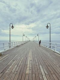 Full length of man standing on pier against sky