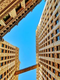 Low angle view of buildings against blue sky