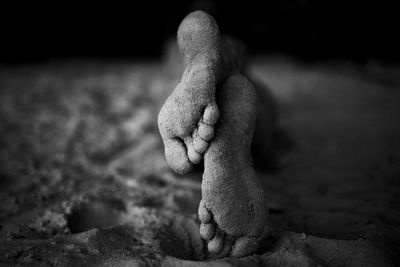 Women's feet in the sand close-up, black and white