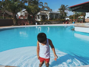 Full length of boy standing in swimming pool