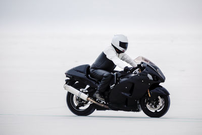 Man riding motorcycle against sky