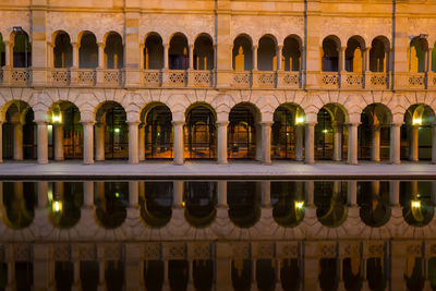 Reflection of building in water at night