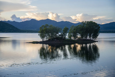 Scenic view of lake and mountains against sky