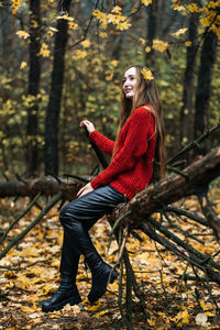 Autumn portrait of candid beautiful girl with fall leaves in hair. portrait of happy woman in fall