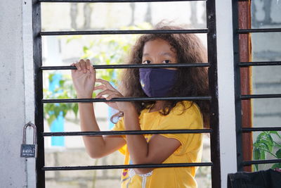 Portrait of woman holding window