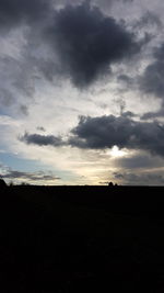 Silhouette landscape against sky during sunset