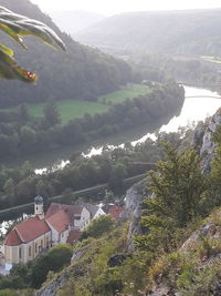 High angle view of houses by river against sky