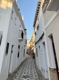 Narrow alley amidst buildings against sky