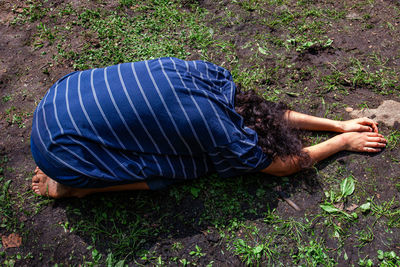 High angle view of man sleeping on field