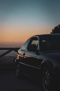 Car on road against sky during sunset