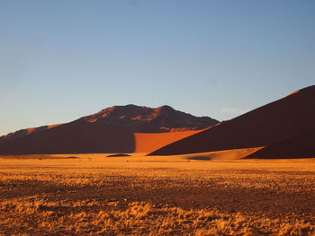 Scenic view of arid landscape against clear sky