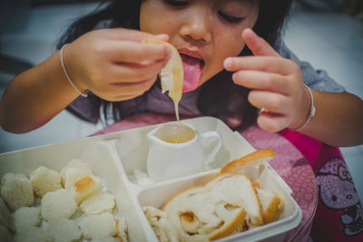 Close-up of girl eating bread