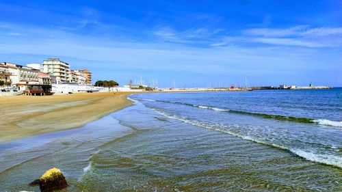 View of beach against buildings in city