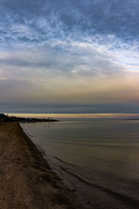 Scenic view of beach against sky during sunset