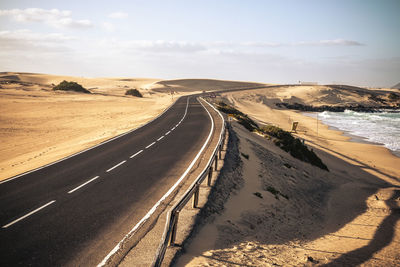 Road by sea against sky