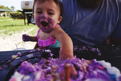 Little girl smashing cake