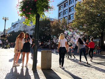 Group of people walking on street in city