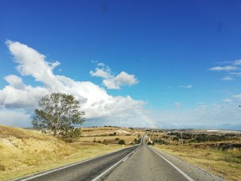 Empty road along countryside landscape