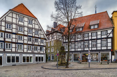 Residential building by street against sky