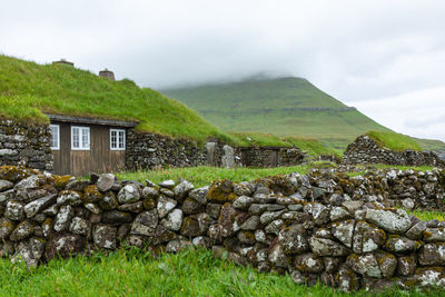 Built structure on field against sky