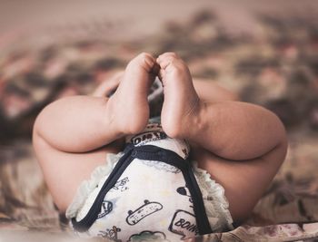 Low section of woman lying on land