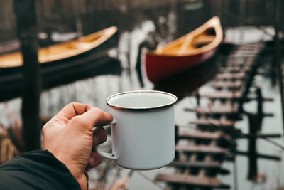 Midsection of woman holding coffee