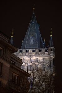 Low angle view of buildings against sky at night