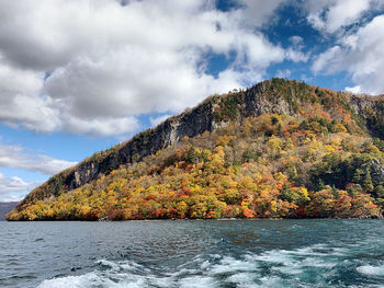 Scenic view of river against sky during autumn