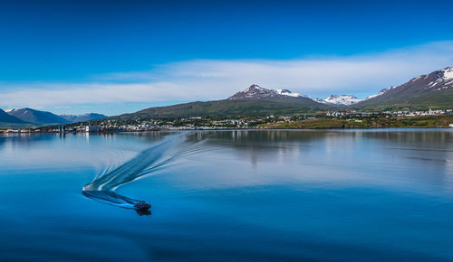 Scenic view of lake against blue sky