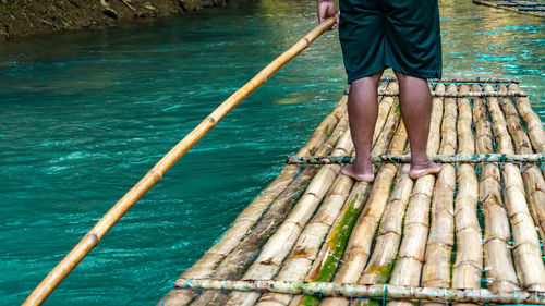 Punting down a river on a bamboo raft
