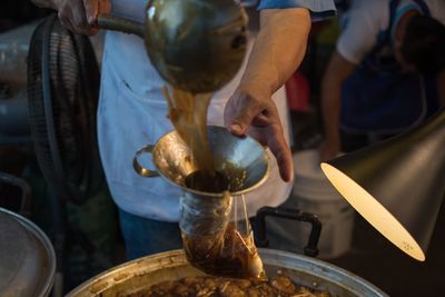 Midsection of man preparing food in kitchen