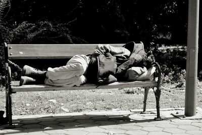 Full length of man sleeping on bench