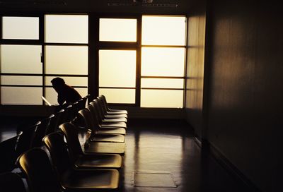 Empty chairs and tables in window