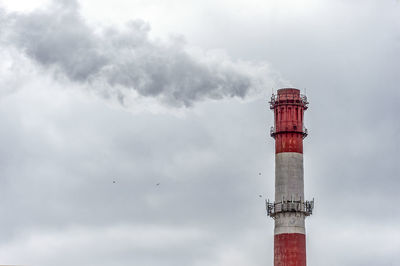 Low angle view of smoke stack against sky