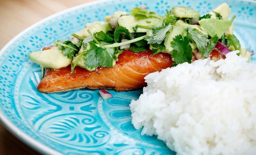 Close-up of salmon filet with avocado and coriander