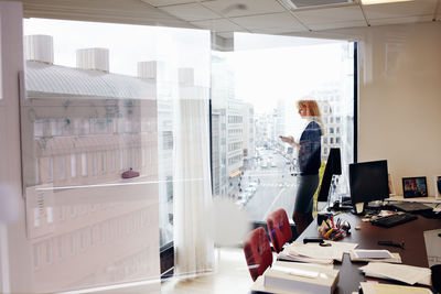 People standing by glass window