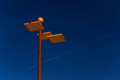 Low angle view of street light against clear blue sky