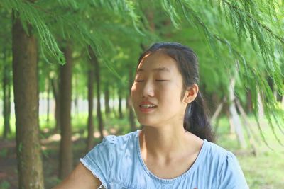 Close-up of young woman in forest
