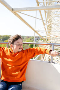 Boy on a ferris wheel in slaghaven park, holland on sunny day