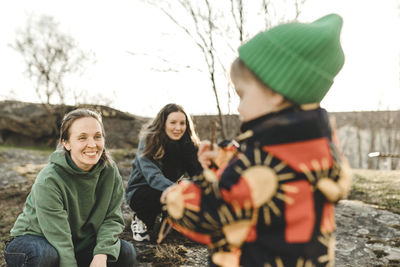 Women playing with daughter outdoor