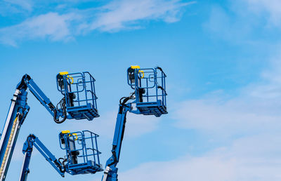 Low angle view of crane against sky