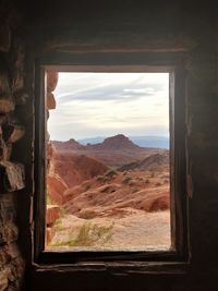 Scenic view of mountains seen through window