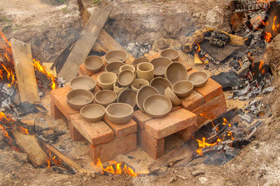 Various ceramic vessels about to be cooked over a campfire