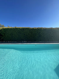 Scenic view of swimming pool against clear blue sky