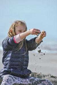 Side view of boy playing in puddle