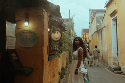 Rear view of woman standing in city