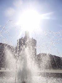 Close-up of water splashing against sky