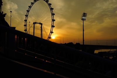 Silhouette ferris wheel against sky during sunset