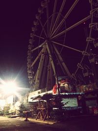 Low angle view of ferris wheel against sky at night