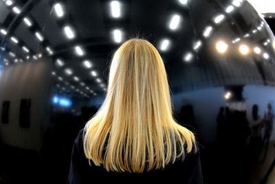 Rear view of woman at night